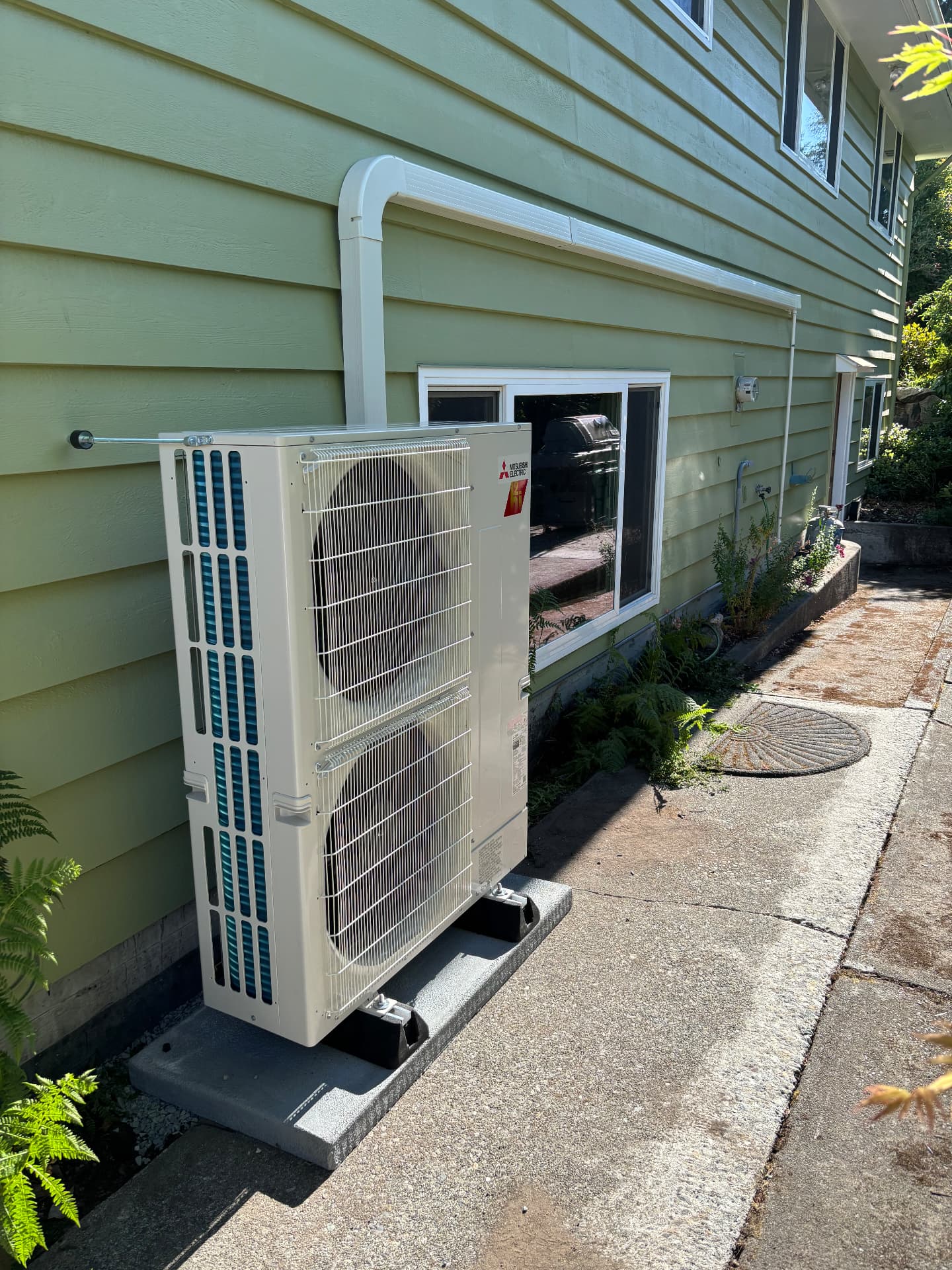 Mitsubishi Electric outdoor unit installed beside a home
