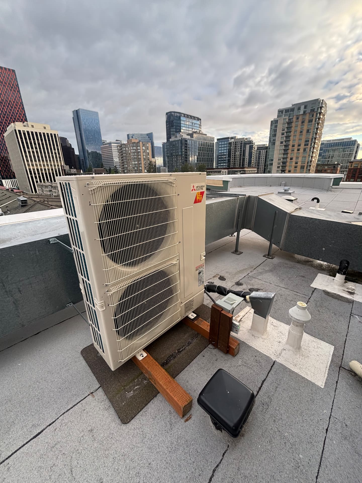 Mitsubishi Electric outdoor unit installed on a city rooftop