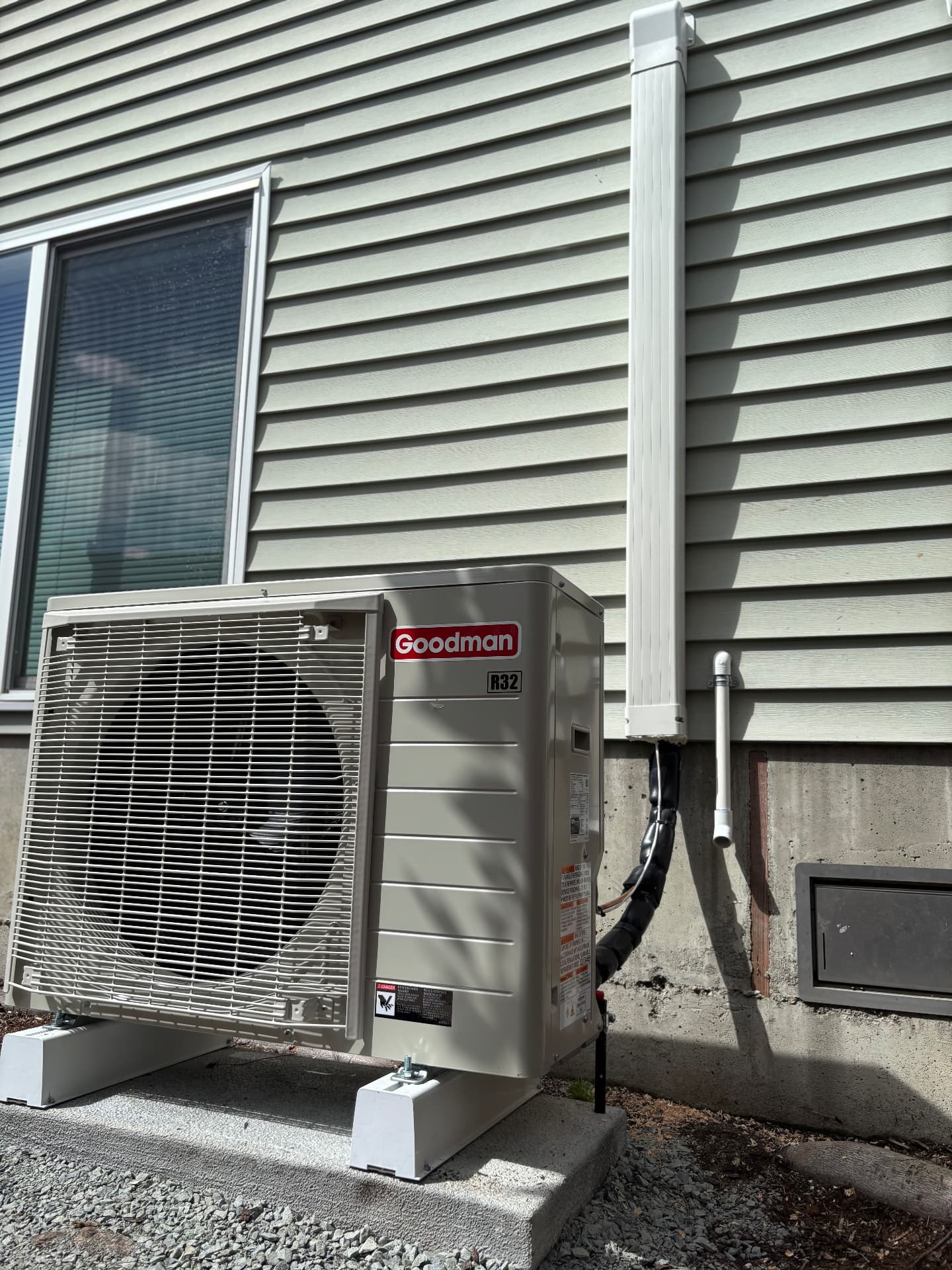Goodman outdoor unit installed beside vinyl siding